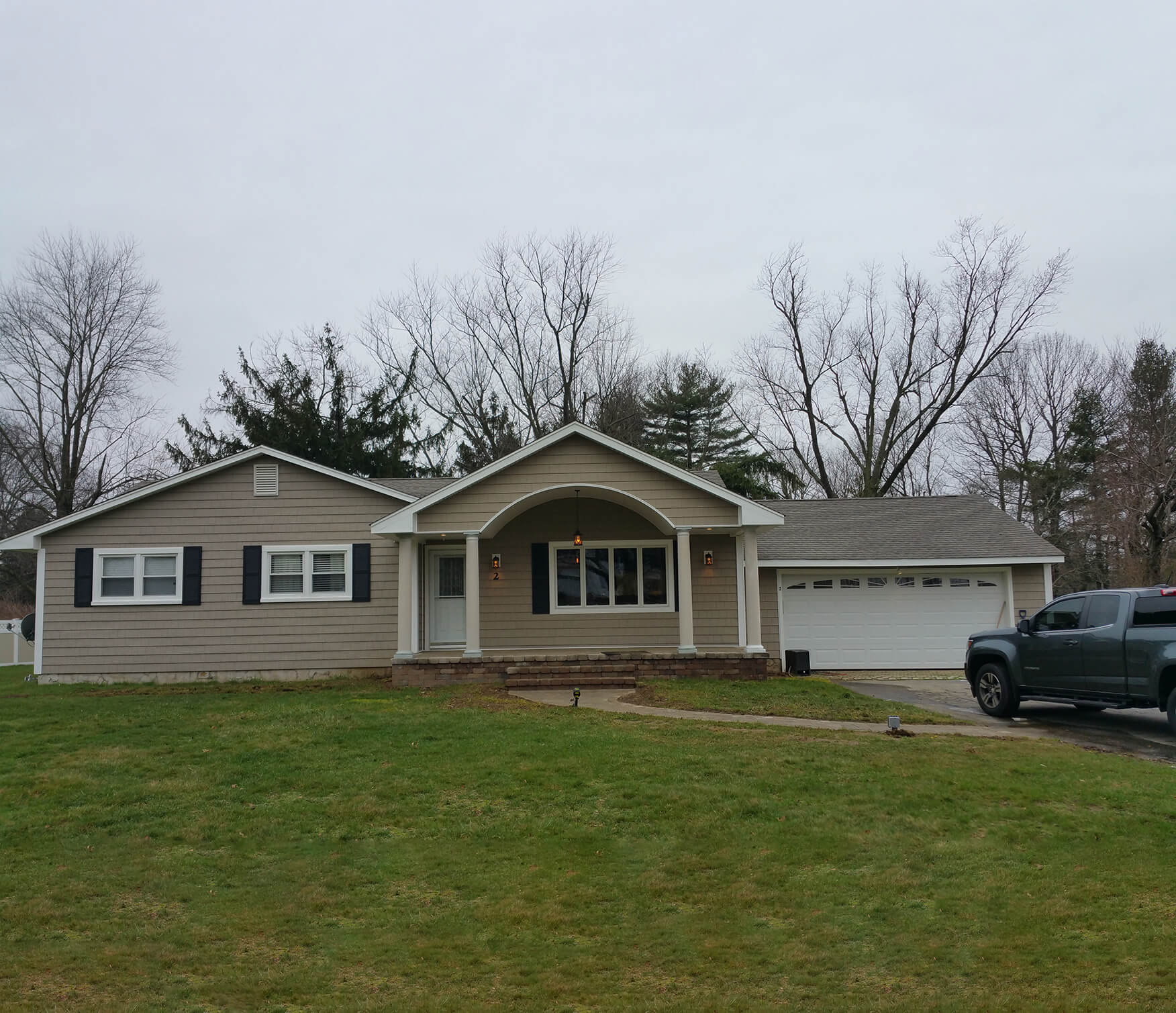 Beige siding arched entry garage image